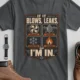 HVAC Technician T‑Shirt — "If It Blows, Leaks, Freezes or Burns I'm In" Retro Tradesmen Tee — asphalt — Flat-lay HVAC Technician T‑Shirt — "If It Blows, Leaks, Freezes or Burns I'm In" Retro Tradesmen Tee — asphalt t-shirt, flat-lay product photo | Pressure Tested Co