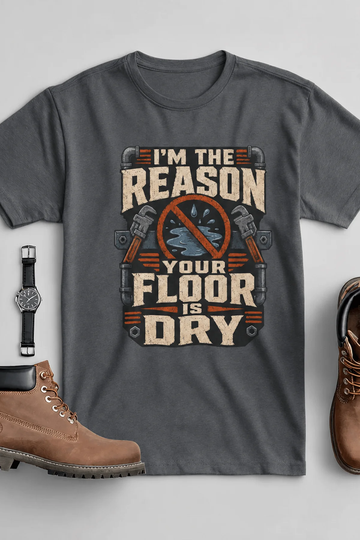 Plumber T‑Shirt – "I'm the Reason Your Floor Is Dry" Vintage Plumbing Tee — asphalt — Flat-lay Plumber T‑Shirt – "I'm the Reason Your Floor Is Dry" Vintage Plumbing Tee — asphalt t-shirt, flat-lay product photo | Pressure Tested Co
