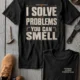 Funny Plumber Repair Graphic Tee "I Solve Problems You Can Smell" Back - "Plumbing Systems Diagnostician" Front — black — Flat-lay Funny Plumber Repair Graphic Tee "I Solve Problems You Can Smell" Back - "Plumbing Systems Diagnostician" Front — black t-shirt, flat-lay product photo | Pressure Tested Co