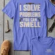 Funny Plumber Repair Graphic Tee "I Solve Problems You Can Smell" Back - "Plumbing Systems Diagnostician" Front — flo-blue — Flat-lay Funny Plumber Repair Graphic Tee "I Solve Problems You Can Smell" Back - "Plumbing Systems Diagnostician" Front — flo-blue t-shirt, flat-lay product photo | Pressure Tested Co