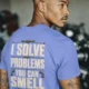 Funny Plumber Repair Graphic Tee "I Solve Problems You Can Smell" Back - "Plumbing Systems Diagnostician" Front — flo-blue — Model Funny Plumber Repair Graphic Tee "I Solve Problems You Can Smell" Back - "Plumbing Systems Diagnostician" Front — flo-blue t-shirt, model photo | Pressure Tested Co
