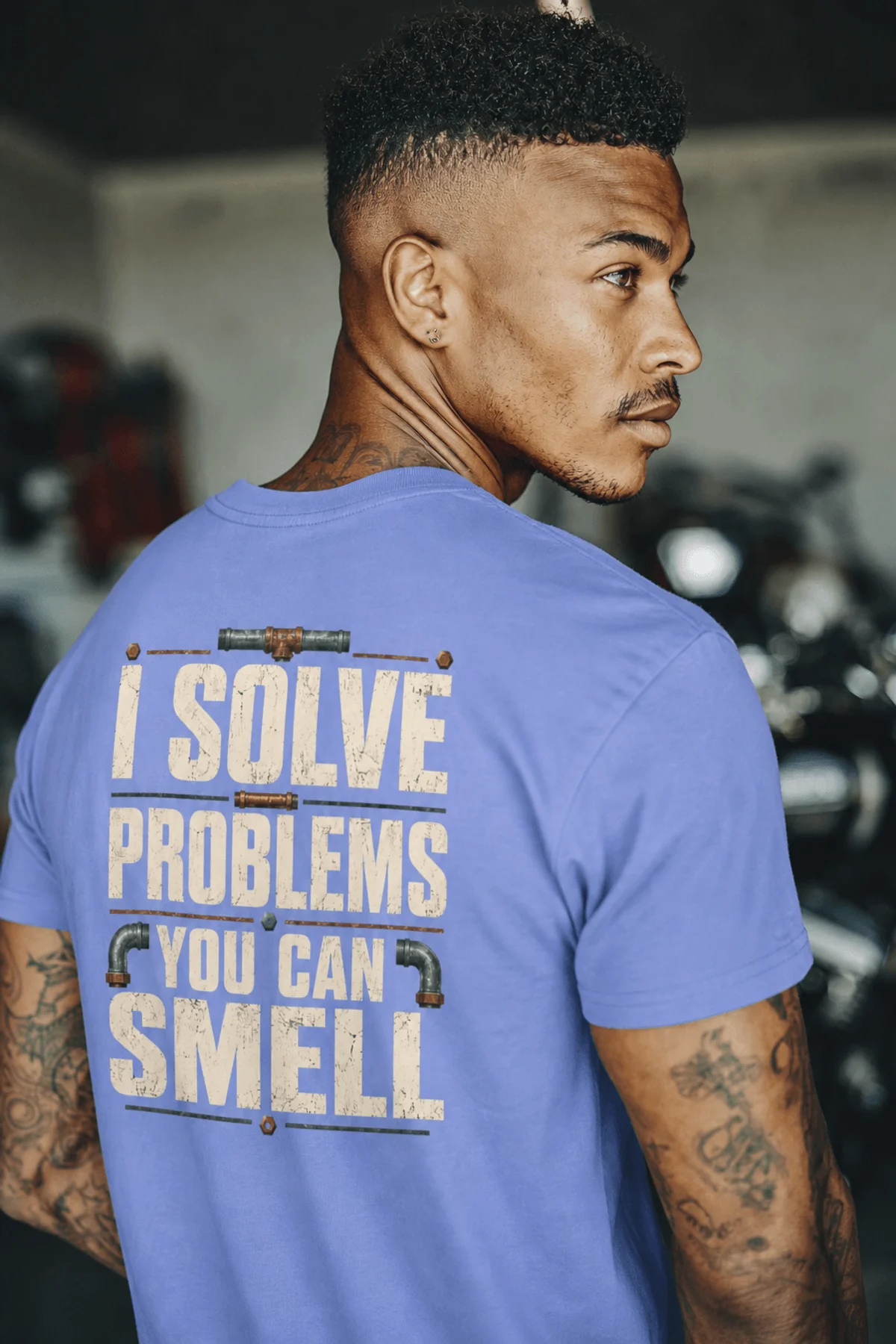 Funny Plumber Repair Graphic Tee "I Solve Problems You Can Smell" Back - "Plumbing Systems Diagnostician" Front — flo-blue — Model Funny Plumber Repair Graphic Tee "I Solve Problems You Can Smell" Back - "Plumbing Systems Diagnostician" Front — flo-blue t-shirt, model photo | Pressure Tested Co