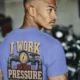 Funny Plumber Repair Graphic Tee "I Work Under Pressure" Back - "Plumbing Systems Diagnostician" Front — flo-blue t-shirt, model photo | Pressure Tested Co