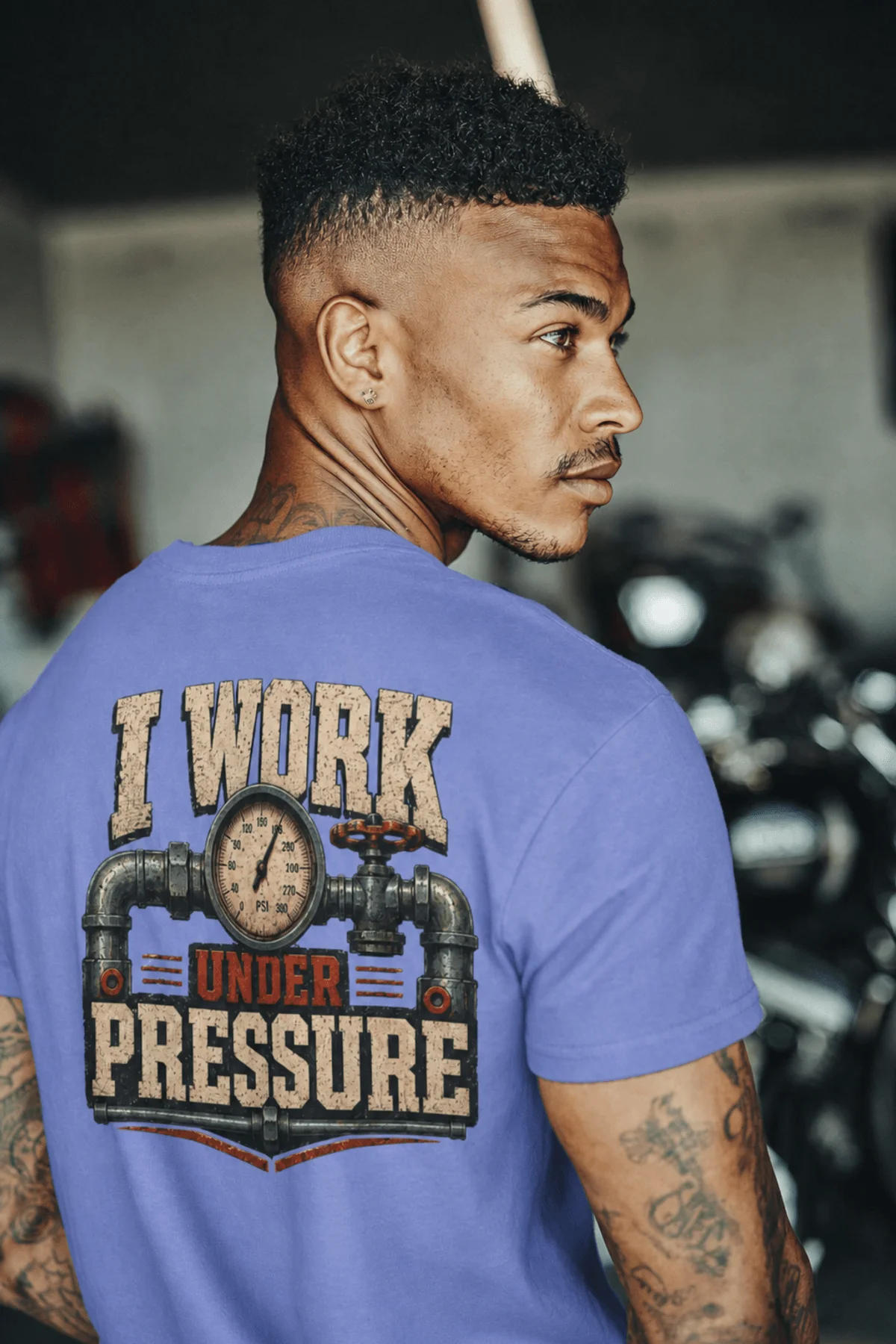 Funny Plumber Repair Graphic Tee "I Work Under Pressure" Back - "Plumbing Systems Diagnostician" Front — flo-blue t-shirt, model photo | Pressure Tested Co