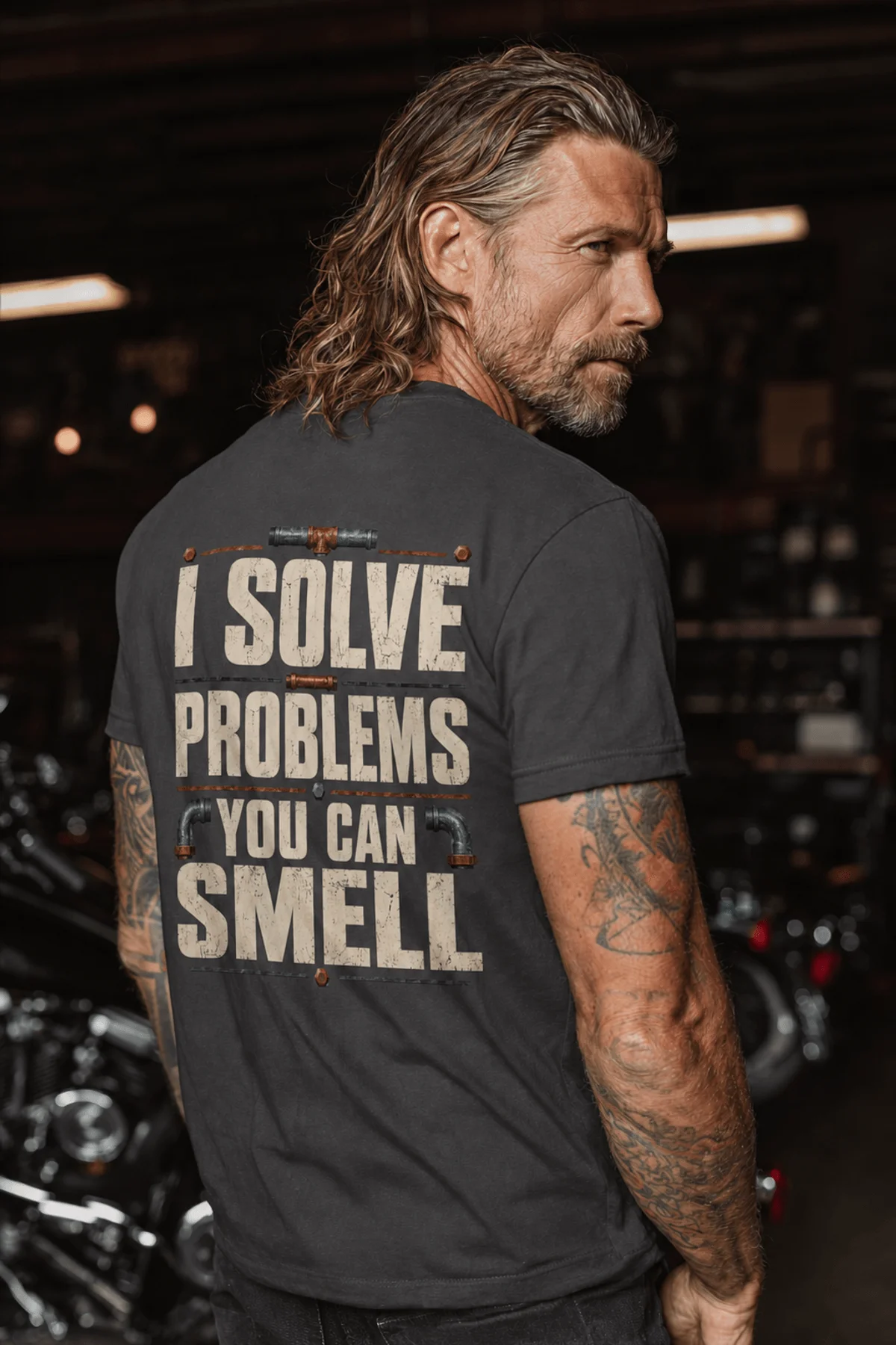 Funny Plumber Repair Graphic Tee "I Solve Problems You Can Smell" Back - "Plumbing Systems Diagnostician" Front — graphite — Model Funny Plumber Repair Graphic Tee "I Solve Problems You Can Smell" Back - "Plumbing Systems Diagnostician" Front — graphite t-shirt, model photo | Pressure Tested Co