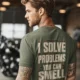 Funny Plumber Repair Graphic Tee "I Solve Problems You Can Smell" Back - "Plumbing Systems Diagnostician" Front — moss — Model Funny Plumber Repair Graphic Tee "I Solve Problems You Can Smell" Back - "Plumbing Systems Diagnostician" Front — moss t-shirt, model photo | Pressure Tested Co