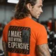 Funny Electrician Tech Tee - Back "I Make Bad Wiring Expensive" — Front "Wired For Success" Vintage Work Tee — orange — Model Funny Electrician Tech Tee - Back "I Make Bad Wiring Expensive" — Front "Wired For Success" Vintage Work Tee — orange t-shirt, model photo | Pressure Tested Co