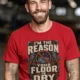 Plumber T‑Shirt – "I'm the Reason Your Floor Is Dry" Vintage Plumbing Tee — red — Model Plumber T‑Shirt – "I'm the Reason Your Floor Is Dry" Vintage Plumbing Tee — red t-shirt, model photo | Pressure Tested Co