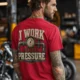 Funny Plumber Repair Graphic Tee "I Work Under Pressure" Back - "Plumbing Systems Diagnostician" Front — red t-shirt, model photo | Pressure Tested Co