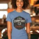 Funny HVAC Tech Tee "I Fix Comfort Crimes" — Furnace and Air Tech Work Tee — steel-blue — Model Funny HVAC Tech Tee "I Fix Comfort Crimes" — Furnace and Air Tech Work Tee — steel-blue t-shirt, model photo | Pressure Tested Co