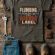 Plumbing Warning Label T-Shirt — Funny Plumber Shirt — army t-shirt, flat-lay product photo | Pressure Tested Co