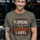 Plumbing Warning Label T-Shirt — Funny Plumber Shirt — army t-shirt, model photo | Pressure Tested Co