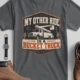 Bucket Truck T-Shirt - “My Other Ride Is A Bucket Truck” Utility Crew/Electrician Tee — asphalt t-shirt, flat-lay product photo | Pressure Tested Co