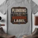 Plumbing Warning Label T-Shirt — Funny Plumber Shirt — athletic-heather t-shirt, flat-lay product photo | Pressure Tested Co