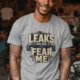 Leaks Fear Me T-Shirt - Funny Plumber Pipes Tee — athletic-heather t-shirt, model photo | Pressure Tested Co