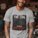 HVAC Technician Tee — “THE COIL WAS DIRTY. SO WAS MY MOOD.” — athletic-heather — Model HVAC Technician Tee — “THE COIL WAS DIRTY. SO WAS MY MOOD.” — athletic-heather t-shirt, model photo | Pressure Tested Co