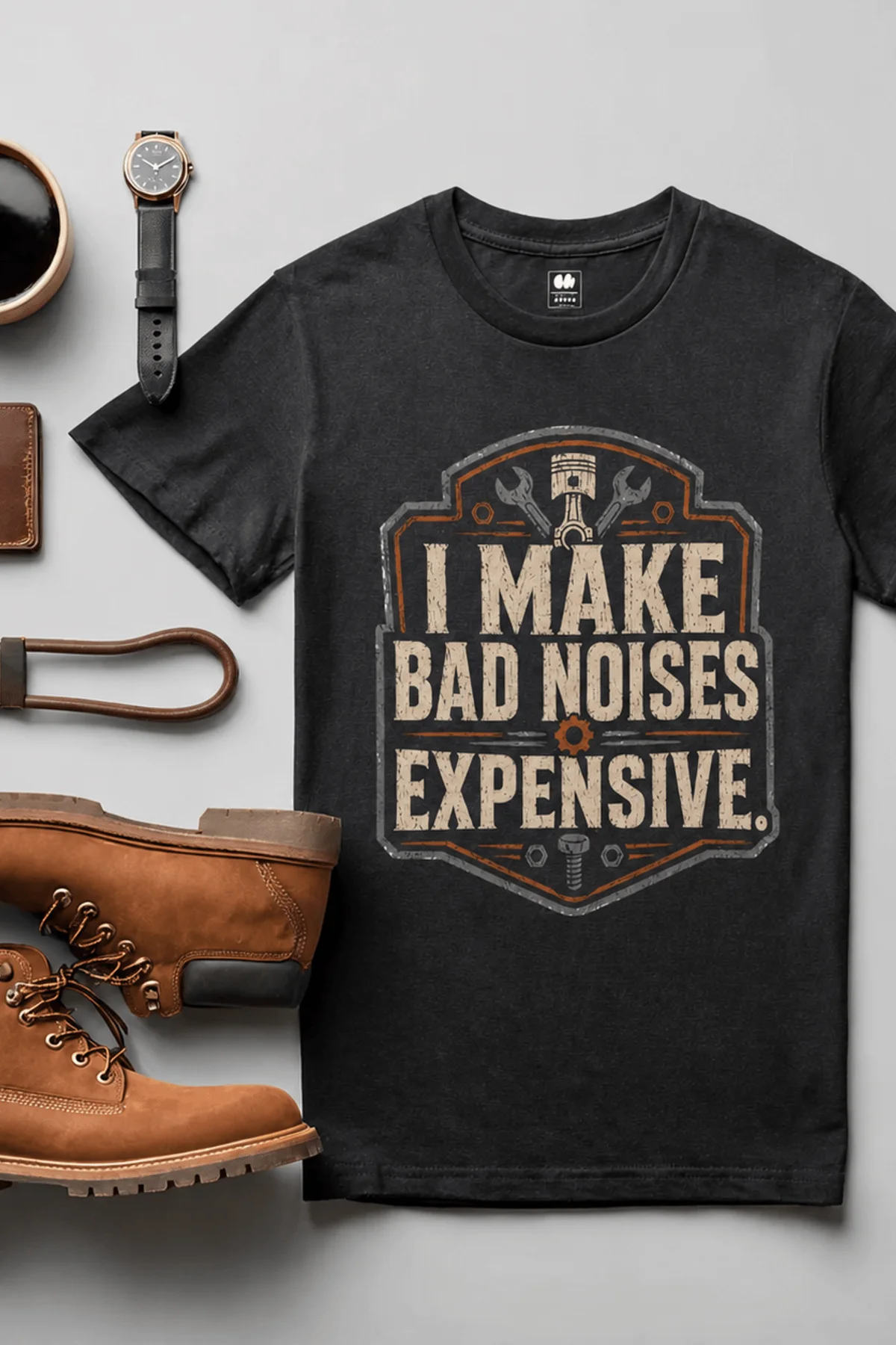 Funny Mechanic Tee - "I Make Bad Noises Expensive" Technician Worker/ Mechanic / Gearhead Tee — black t-shirt, flat-lay product photo | Pressure Tested Co