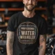 Funny Plumber Tee - "Professional Water Wrangler" Rustic Rope Graphic T-Shirt — black t-shirt, model photo | Pressure Tested Co