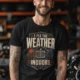 Funny HVAC Technician Tee - “I Fix The Weather Indoors.” Cooling/Furnace Shop Work Shirt — black — Model Funny HVAC Technician Tee - “I Fix The Weather Indoors.” Cooling/Furnace Shop Work Shirt — black t-shirt, model photo | Pressure Tested Co