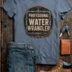 Funny Plumber Tee - "Professional Water Wrangler" Rustic Rope Graphic T-Shirt — blue-jean t-shirt, flat-lay product photo | Pressure Tested Co