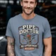 Plumber T-Shirt — "Pipe Doctor. No Appointment Needed" Vintage Work Shirt — blue-jean — Model Plumber T-Shirt — "Pipe Doctor. No Appointment Needed" Vintage Work Shirt — blue-jean t-shirt, model photo | Pressure Tested Co