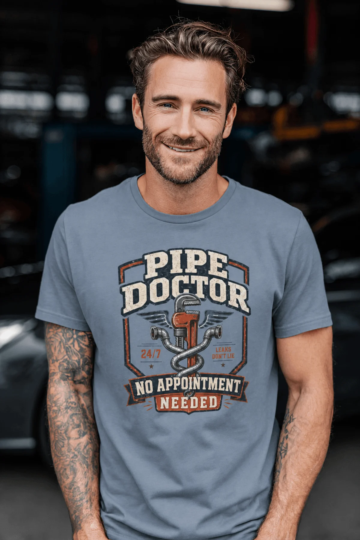 Plumber T-Shirt — "Pipe Doctor. No Appointment Needed" Vintage Work Shirt — blue-jean — Model Plumber T-Shirt — "Pipe Doctor. No Appointment Needed" Vintage Work Shirt — blue-jean t-shirt, model photo | Pressure Tested Co