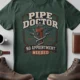 Plumber T-Shirt — "Pipe Doctor. No Appointment Needed" Vintage Work Shirt — blue-spruce — Flat-lay Plumber T-Shirt — "Pipe Doctor. No Appointment Needed" Vintage Work Shirt — blue-spruce t-shirt, flat-lay product photo | Pressure Tested Co