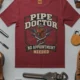 Plumber T-Shirt — "Pipe Doctor. No Appointment Needed" Vintage Work Shirt — chili — Flat-lay Plumber T-Shirt — "Pipe Doctor. No Appointment Needed" Vintage Work Shirt — chili t-shirt, flat-lay product photo | Pressure Tested Co