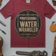 Funny Plumber Tee - "Professional Water Wrangler" Rustic Rope Graphic T-Shirt — chili t-shirt, flat-lay product photo | Pressure Tested Co