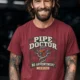 Plumber T-Shirt — "Pipe Doctor. No Appointment Needed" Vintage Work Shirt — chili — Model Plumber T-Shirt — "Pipe Doctor. No Appointment Needed" Vintage Work Shirt — chili t-shirt, model photo | Pressure Tested Co