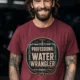 Funny Plumber Tee - "Professional Water Wrangler" Rustic Rope Graphic T-Shirt — chili t-shirt, model photo | Pressure Tested Co