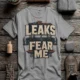 Leaks Fear Me T-Shirt - Funny Plumber Pipes Tee — dark-grey t-shirt, flat-lay product photo | Pressure Tested Co