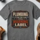 Plumbing Warning Label T-Shirt — Funny Plumber Shirt — deep-heather t-shirt, flat-lay product photo | Pressure Tested Co