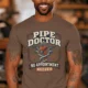 Plumber T-Shirt — "Pipe Doctor. No Appointment Needed" Vintage Work Shirt — espresso — Model Plumber T-Shirt — "Pipe Doctor. No Appointment Needed" Vintage Work Shirt — espresso t-shirt, model photo | Pressure Tested Co