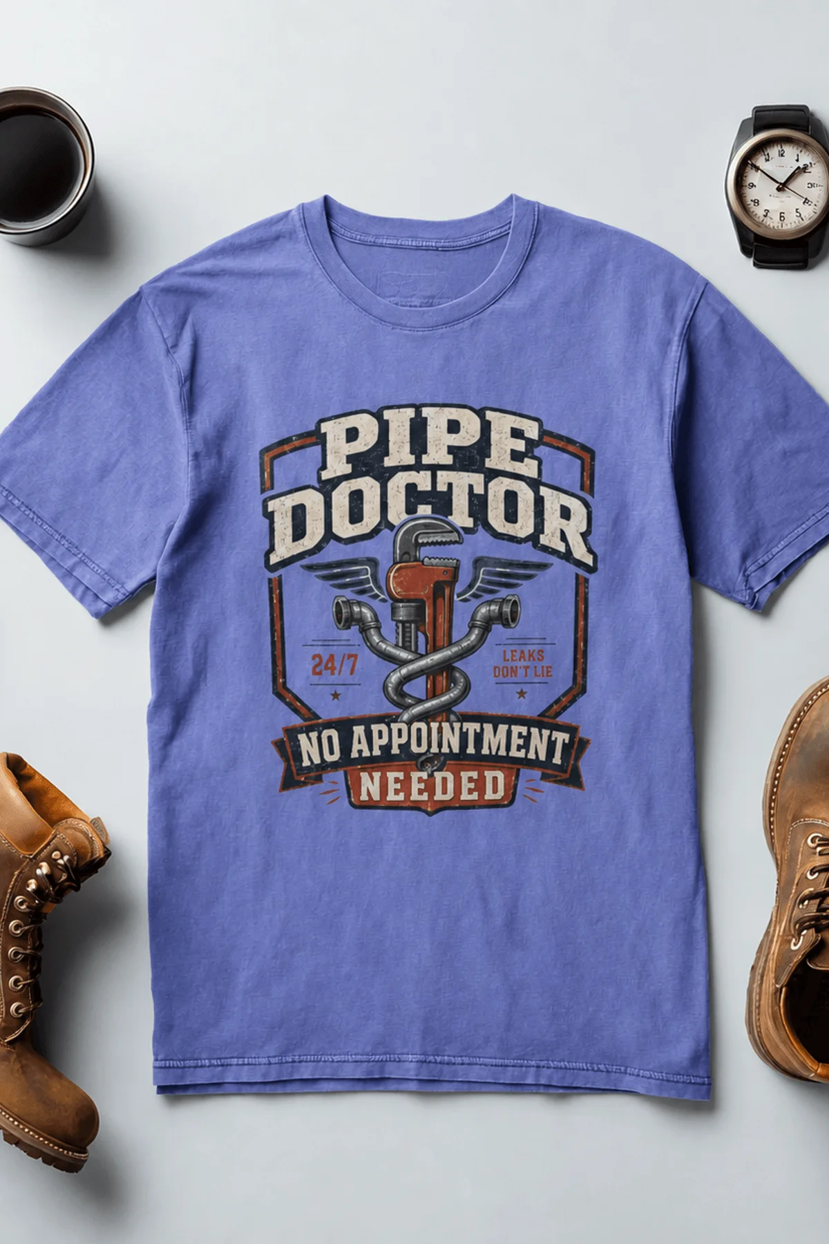 Plumber T-Shirt — "Pipe Doctor. No Appointment Needed" Vintage Work Shirt — flo-blue — Flat-lay Plumber T-Shirt — "Pipe Doctor. No Appointment Needed" Vintage Work Shirt — flo-blue t-shirt, flat-lay product photo | Pressure Tested Co