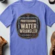 Funny Plumber Tee - "Professional Water Wrangler" Rustic Rope Graphic T-Shirt — flo-blue t-shirt, flat-lay product photo | Pressure Tested Co