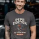 Plumber T-Shirt — "Pipe Doctor. No Appointment Needed" Vintage Work Shirt — graphite — Model Plumber T-Shirt — "Pipe Doctor. No Appointment Needed" Vintage Work Shirt — graphite t-shirt, model photo | Pressure Tested Co