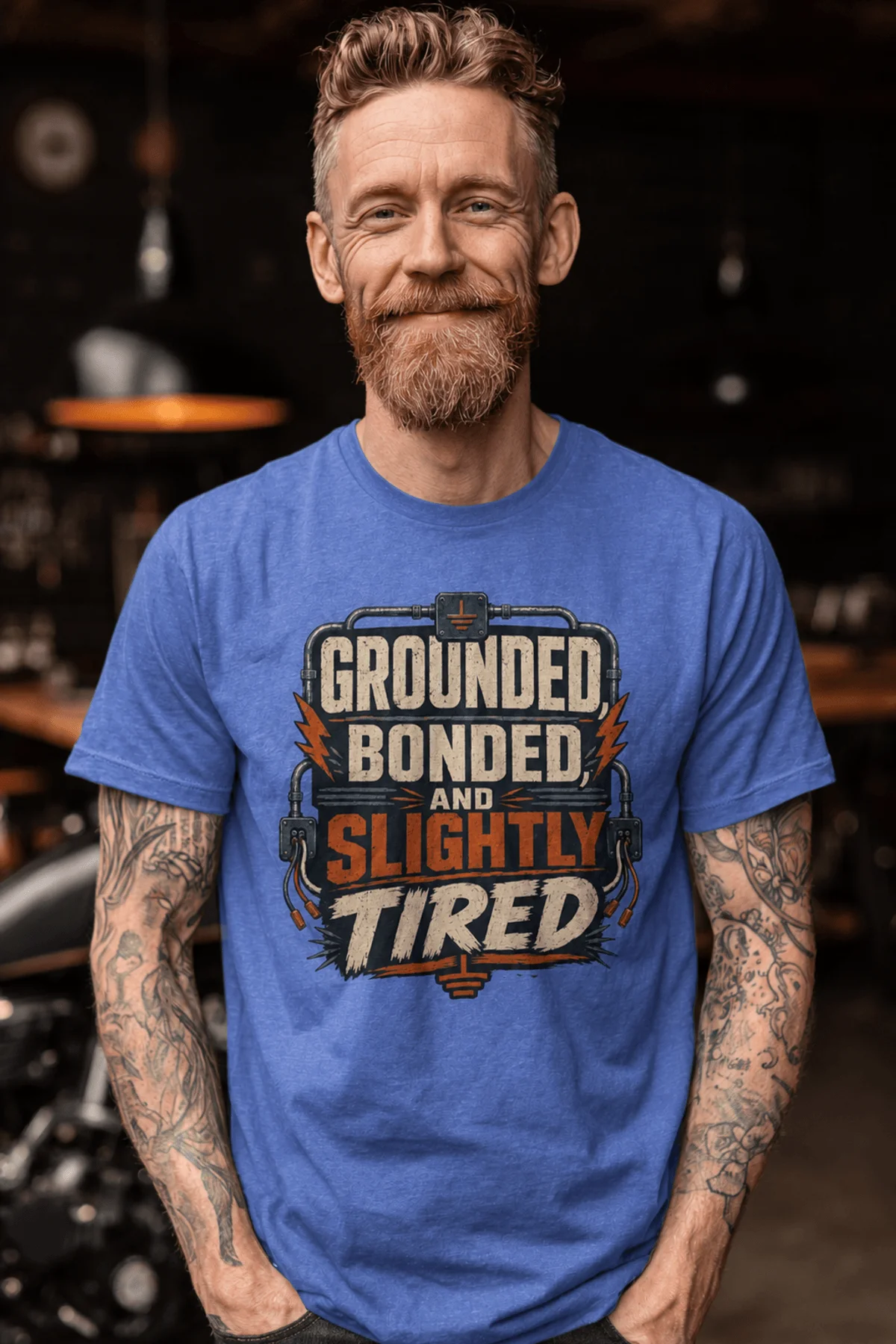 Grounded, Bonded and Slightly Tired Graphic Tee — Funny Electrical Worker Shirt — heather-columbia-blue t-shirt, model photo | Pressure Tested Co