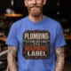 Plumbing Warning Label T-Shirt — Funny Plumber Shirt — heather-columbia-blue t-shirt, model photo | Pressure Tested Co