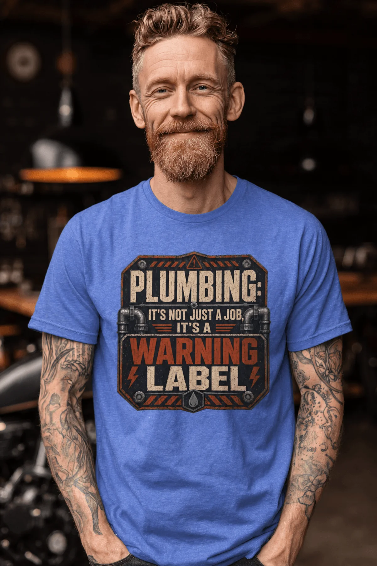 Plumbing Warning Label T-Shirt — Funny Plumber Shirt — heather-columbia-blue t-shirt, model photo | Pressure Tested Co