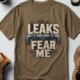 Leaks Fear Me T-Shirt - Funny Plumber Pipes Tee — heather-olive t-shirt, flat-lay product photo | Pressure Tested Co