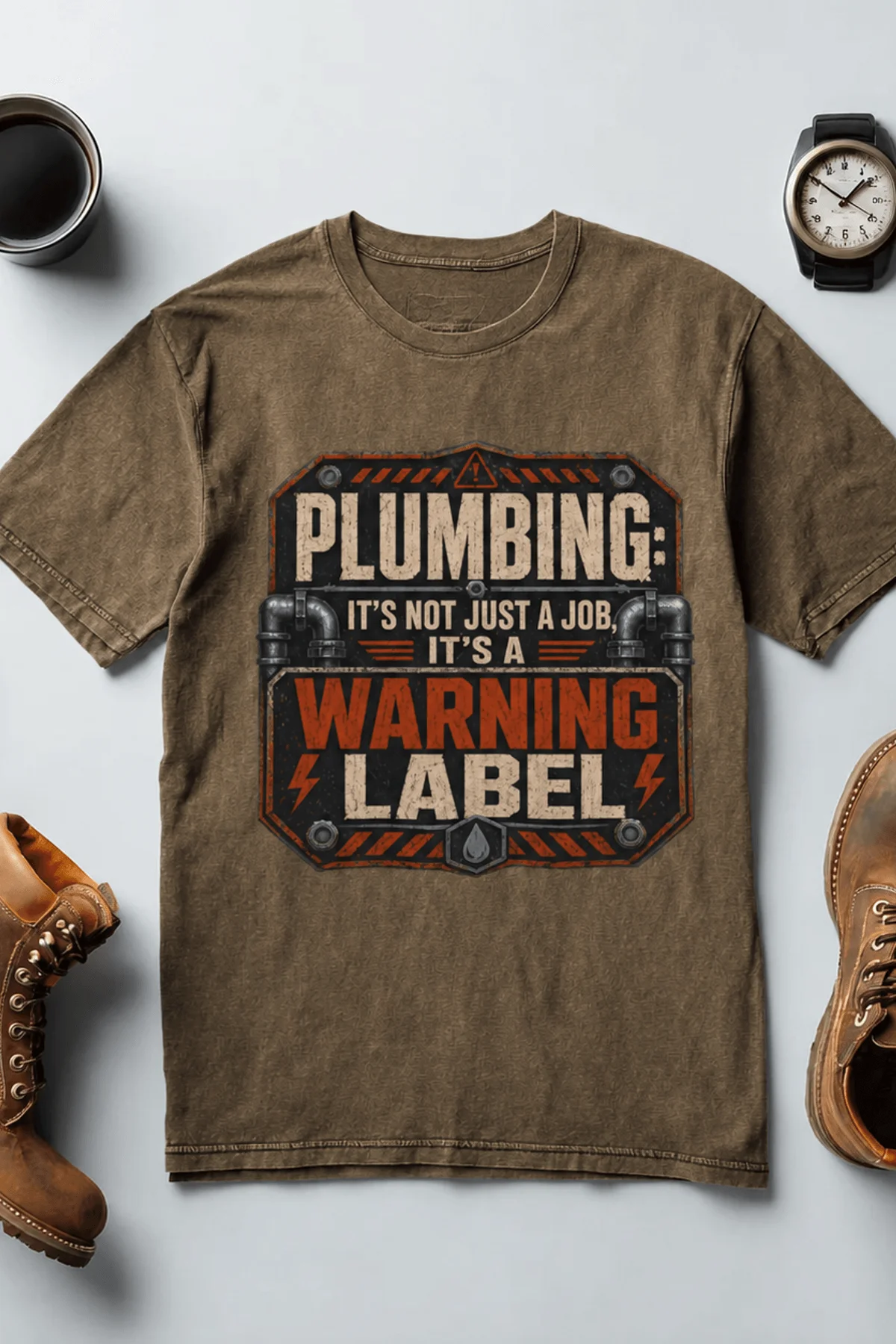 Plumbing Warning Label T-Shirt — Funny Plumber Shirt — heather-olive t-shirt, flat-lay product photo | Pressure Tested Co
