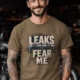Leaks Fear Me T-Shirt - Funny Plumber Pipes Tee — heather-olive t-shirt, model photo | Pressure Tested Co