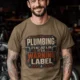 Plumbing Warning Label T-Shirt — Funny Plumber Shirt — heather-olive t-shirt, model photo | Pressure Tested Co
