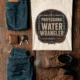 Funny Plumber Tee - "Professional Water Wrangler" Rustic Rope Graphic T-Shirt — ivory t-shirt, flat-lay product photo | Pressure Tested Co
