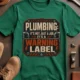 Plumbing Warning Label T-Shirt — Funny Plumber Shirt — kelly t-shirt, flat-lay product photo | Pressure Tested Co