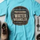 Funny Plumber Tee - "Professional Water Wrangler" Rustic Rope Graphic T-Shirt — lagoon-blue t-shirt, flat-lay product photo | Pressure Tested Co