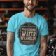 Funny Plumber Tee - "Professional Water Wrangler" Rustic Rope Graphic T-Shirt — lagoon-blue t-shirt, model photo | Pressure Tested Co