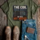 HVAC Technician Tee — “THE COIL WAS DIRTY. SO WAS MY MOOD.” — military-green — Flat-lay HVAC Technician Tee — “THE COIL WAS DIRTY. SO WAS MY MOOD.” — military-green t-shirt, flat-lay product photo | Pressure Tested Co