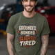 Grounded, Bonded and Slightly Tired Graphic Tee — Funny Electrical Worker Shirt — military-green t-shirt, model photo | Pressure Tested Co